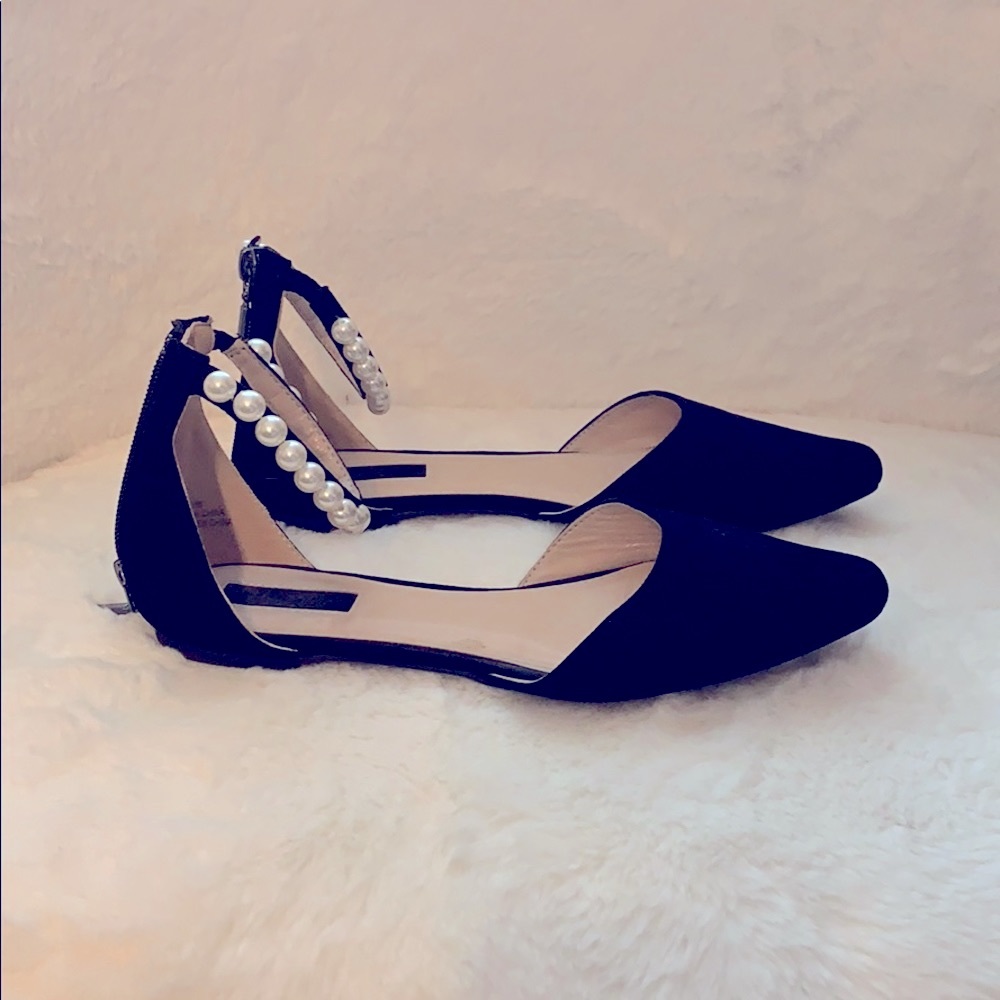 Black flats with pearls around ankle